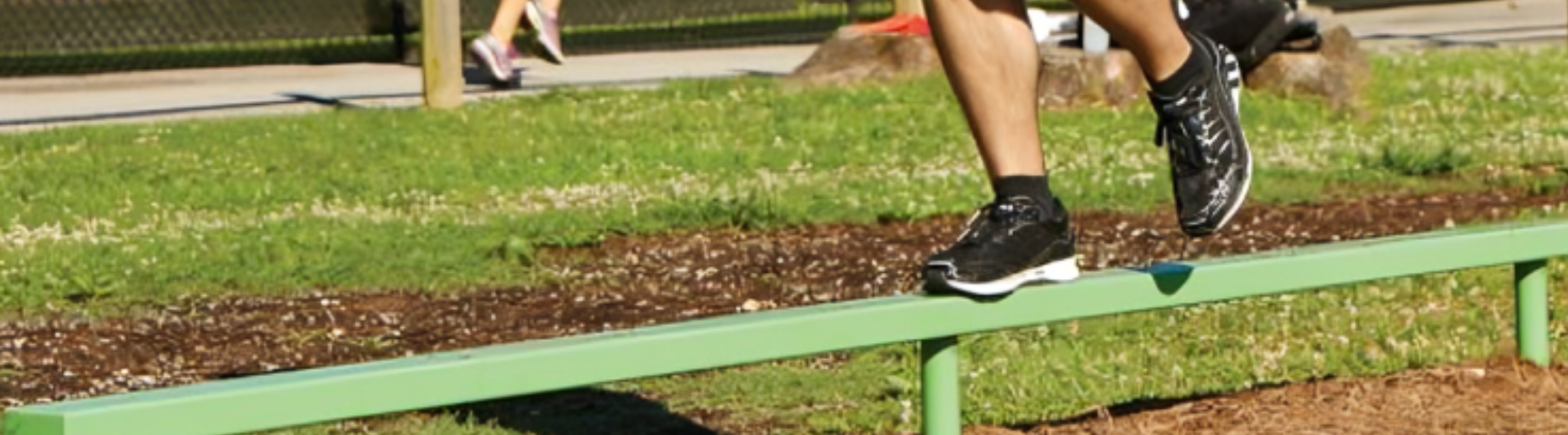 Person walking across low balance beam